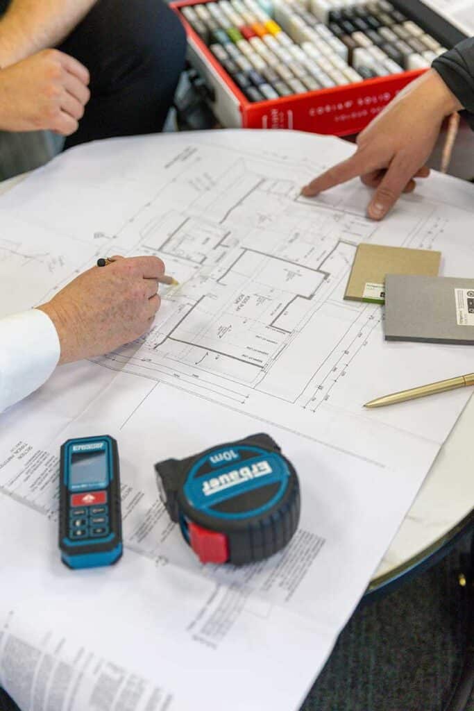 Interior designer and contractor reviewing plans for a home renovation